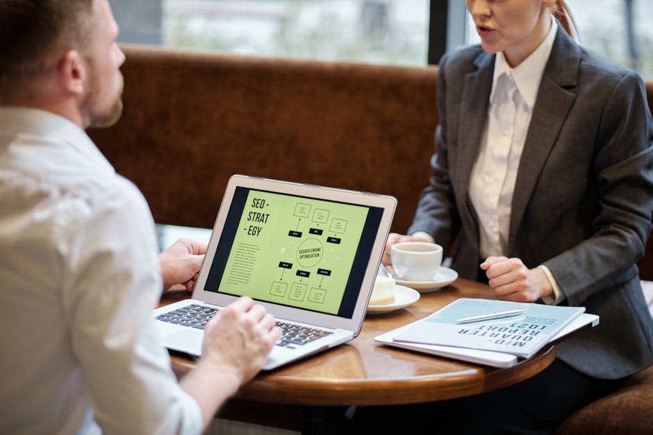 Small business owner at computer analyzing SEO metrics and ranking data